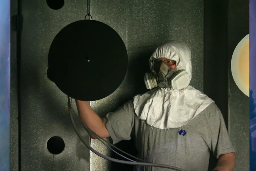 Technician in a full protective suit and respirator