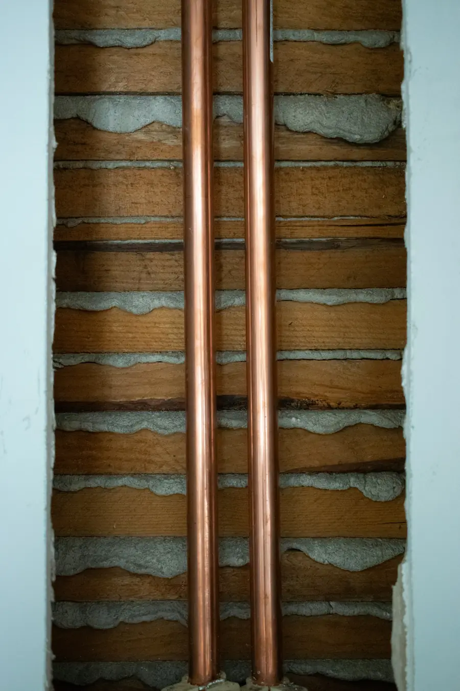 Copper water lines exposed inside an opened wall