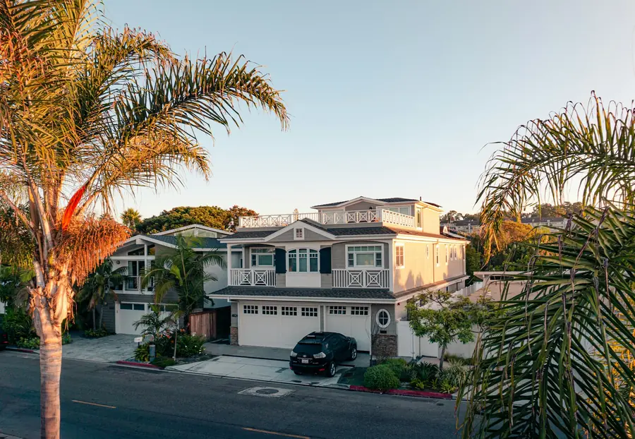 Two story Southern California home with palm trees in the front yard